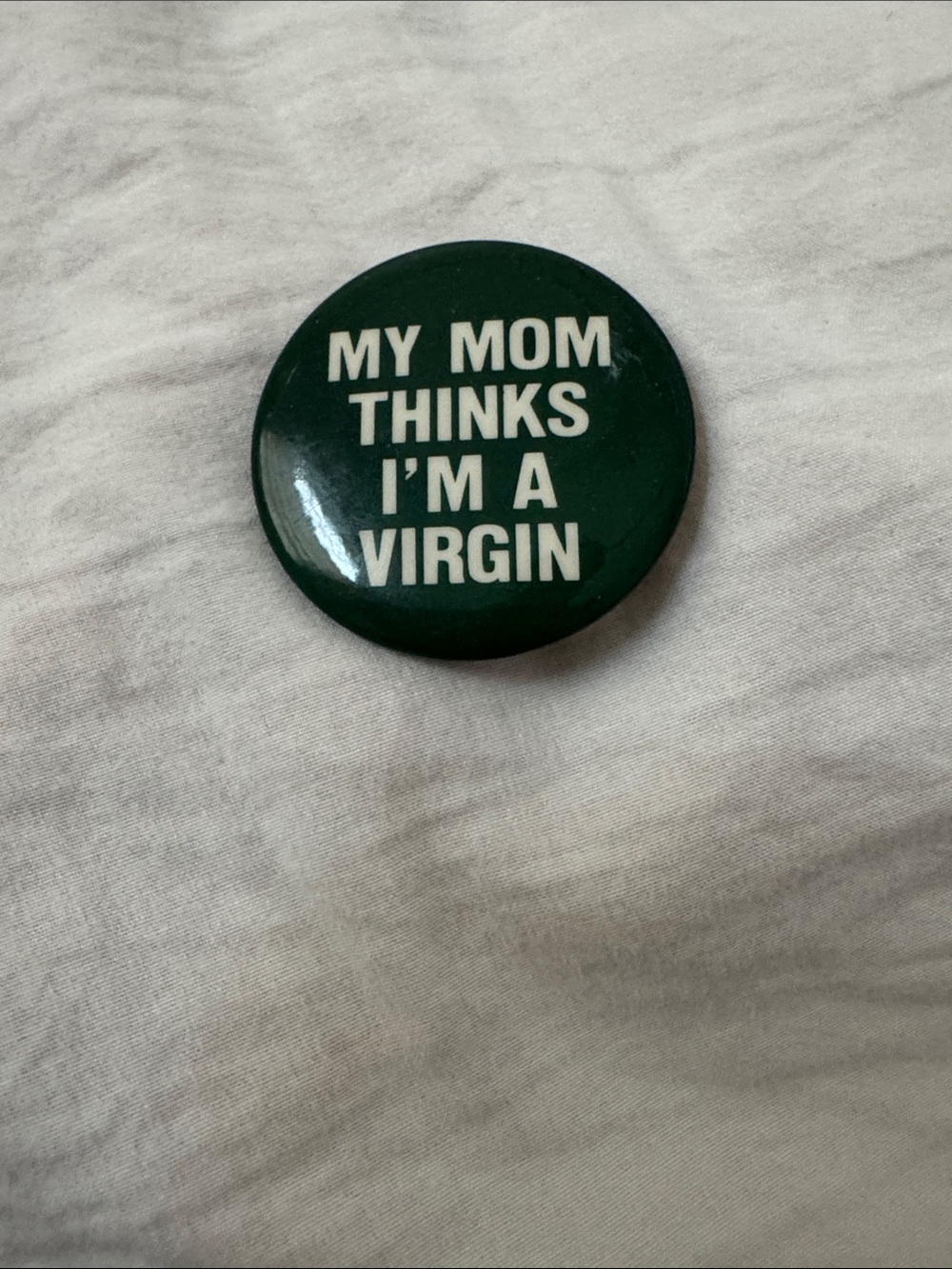 Dark green, funny saying backpack button - approx. half dollar size.